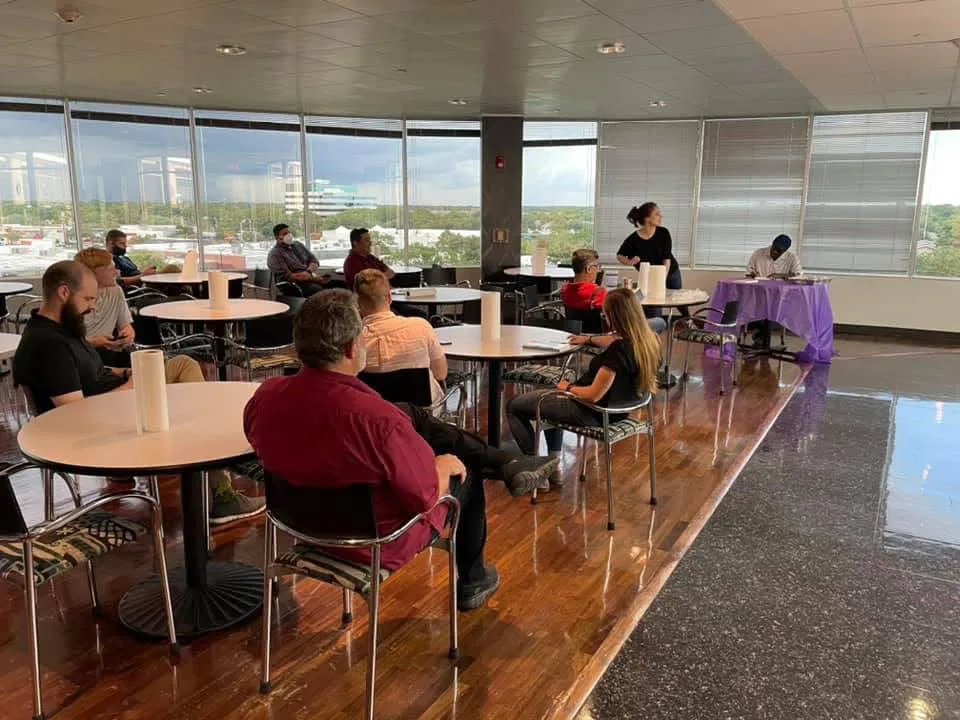 Audience seated in a bright room during a book event
