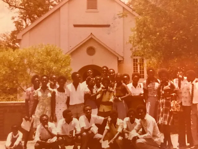 Large group gathered outside a church during Abel's school years in Zambia