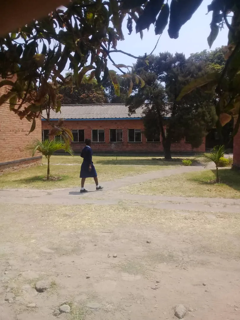 Student walking across the grounds of Mitobo Primary School in Kalulushi, Zambia
